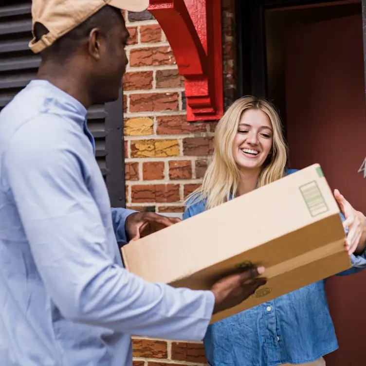 A driver handing a parcel to a customer